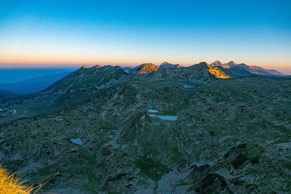 Sunrise over the ridge, with Tevno Lake below
